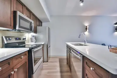 a kitchen with a sink and a refrigerator at Hideaway 2BR Condo Pool & Heated Pool in Shanty Bay