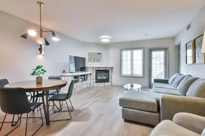 a living room with a couch and a table at Hideaway 2BR Condo Pool & Heated Pool in Shanty Bay