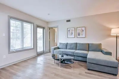 a living room with a couch and a table at Hideaway 2BR Condo Pool & Heated Pool in Shanty Bay