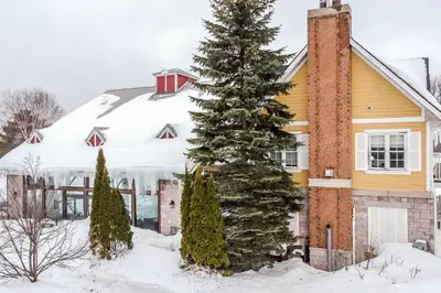 a house with a christmas tree in the snow at Hideaway 2BR Condo Pool & Heated Pool in Shanty Bay