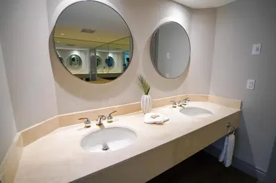 a bathroom with two sinks and a large mirror at Lower Level LuxSuite - 1min Walk from Heated Pool! in Shanty Bay