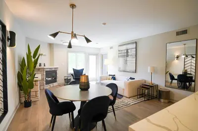 a living room with a table and chairs and a couch at Lower Level LuxSuite - 1min Walk from Heated Pool! in Shanty Bay