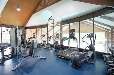 a gym with a bunch of treadms and cardio machines at Lower Level LuxSuite - 1min Walk from Heated Pool! in Shanty Bay