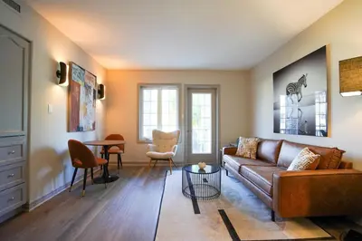 a living room with a couch and a table at Lower Level LuxSuite - 1min Walk from Heated Pool! in Shanty Bay
