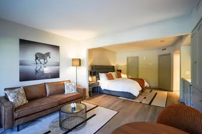 a living room with a bed and a couch at Modern, fully renovated Studio! in Shanty Bay