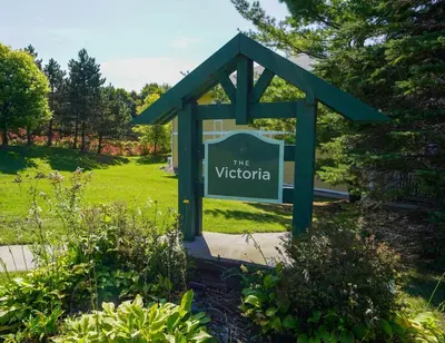 a sign for the victoria in a garden at Modern, fully renovated Studio! in Shanty Bay