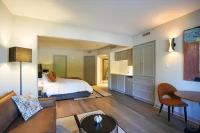 a living room with a bed and a kitchen at Modern, fully renovated Studio! in Shanty Bay