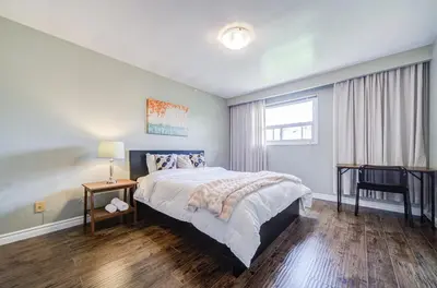 a bedroom with a large bed and a window at Nest in the Orchard--cozy room in Toronto