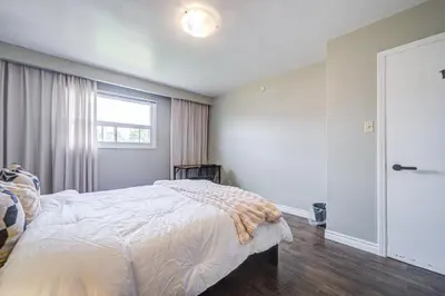 a bedroom with a bed and a window at Nest in the Orchard--cozy room in Toronto