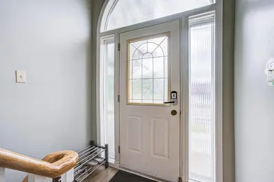 a white door in a hallway with a window at Nest in the Orchard--cozy room in Toronto