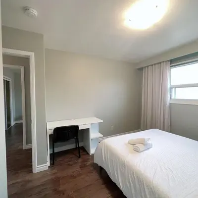 a bedroom with a bed and a desk and a desk at Nest in the Orchard--cozy room in Toronto
