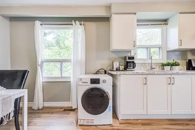 a kitchen with a washing machine in a kitchen at Nest in the Orchard--cozy room in Toronto