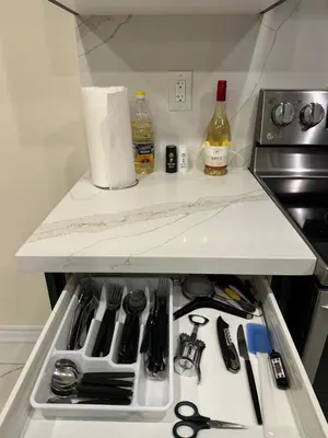 a refrigerator with a drawer full of kitchen utensils at World Cup Soccer Fans Stay! Luxury 4BR Family Retreat in Thorold, Just 10 Mins Niagara Falls, Clifton Hill & Wineries Free Wi-Fi, Free Parking in Thorold