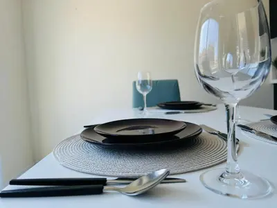 a table with a plate and a wine glass at World Cup Soccer Fans Stay! Luxury 4BR Family Retreat in Thorold, Just 10 Mins Niagara Falls, Clifton Hill & Wineries Free Wi-Fi, Free Parking in Thorold