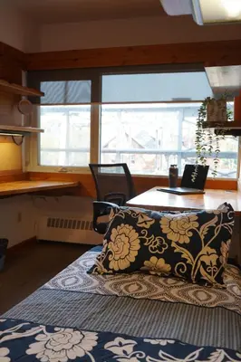 a room with a table and a pillow on a bed at Tartu College Student Residence in Toronto