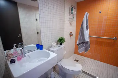 a bathroom with a white toilet and a sink at Tartu College Student Residence in Toronto