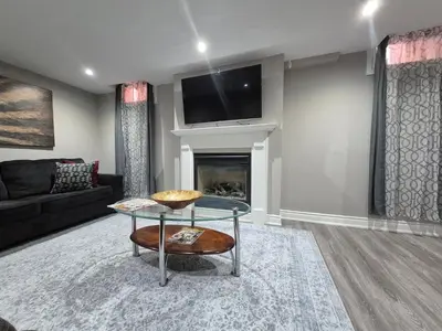 a living room with a couch and a table at Two bedroom basement apartment in Whitby