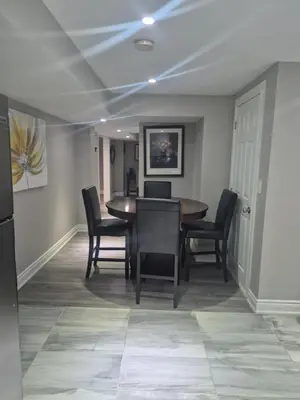 a dining room with a table and chairs at Two bedroom basement apartment in Whitby