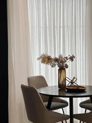 a table with chairs and a vase with flowers on it at INFIVILLA King Suites & Towers Soho Toronto in Toronto