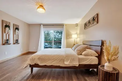 a bedroom with a large bed and a window at Luxurious waterfront cottage in Bowmanville