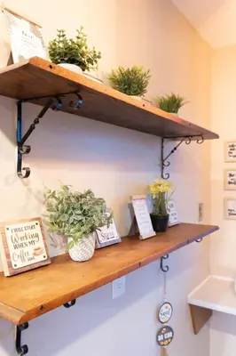a wooden shelf with potted plants on it at Luxurious waterfront cottage in Bowmanville