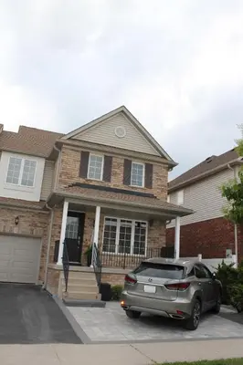a car parked in front of a house at Queen Bed Suite-Private Entrance in Barrie