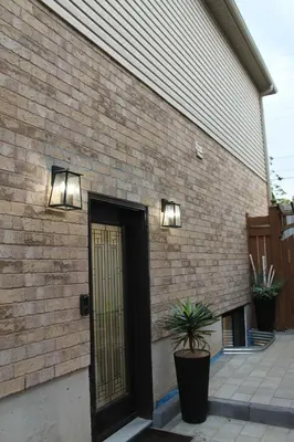 a brick building with a door and lights on it at Queen Bed Suite-Private Entrance in Barrie