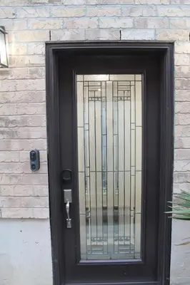 a black door with a metal gate on a brick wall at Queen Bed Suite-Private Entrance in Barrie