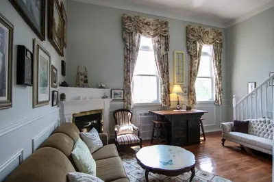 a living room with a couch and a fireplace at The Jypsy Inn - The Royal Suite Bracebridge in Bracebridge