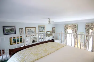 a bedroom with a bed and some pictures on the wall at The Jypsy Inn - The Royal Suite Bracebridge in Bracebridge