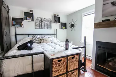 a bedroom with a bed and a fireplace at The Jypsy Inn - Tuxedo Room Muskoka in Bracebridge