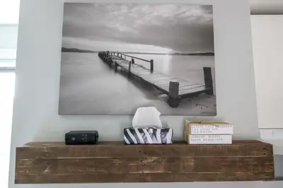 a black and white picture of a dock on the water at The Jypsy Inn - Tuxedo Room Muskoka in Bracebridge