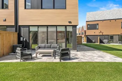 a house with a patio with a couch and benches at Luxury Muskoka Retreat in Gravenhurst