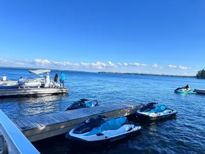 people on a dock with boats on the water at Cozy 1BR Garden Suite Innisfil Beach Park in Innisfil