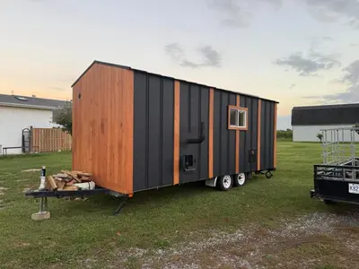 a black and orange tiny house on a trailer at Wonderful house in Niagara on the Lake