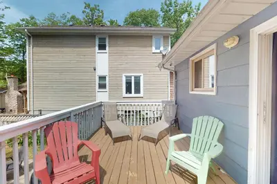 two chairs sitting on a deck in front of a house at Wavy Daze in Wasaga Beach
