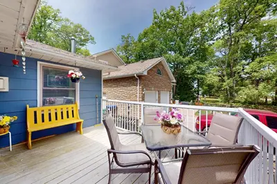 a patio with a table and chairs on a deck at Wavy Daze in Wasaga Beach