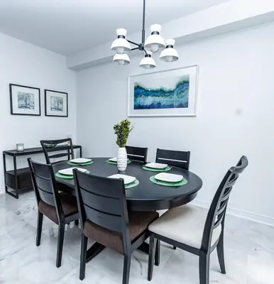 a dining room with a black table and chairs at Vacation Home in Vaughan in Vaughan