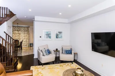 a living room with two chairs and a tv at Vacation Home in Vaughan in Vaughan