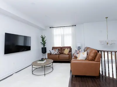 a living room with two couches and a tv at Vacation Home in Vaughan in Vaughan