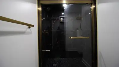 a shower with a glass door in a bathroom at Beautiful Separate Unit, GrandRiver & Kiwanis Park in Kitchener