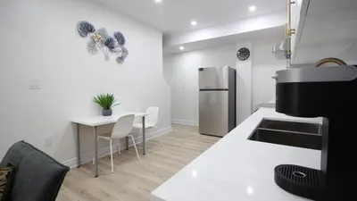 a kitchen with a white counter and a refrigerator at Beautiful Separate Unit, GrandRiver & Kiwanis Park in Kitchener