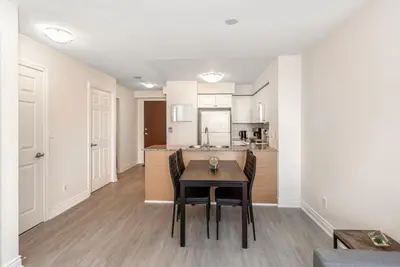 a kitchen and dining room with a table and chairs at Stylish 2BR with Great View! Steps from Square One in Mississauga