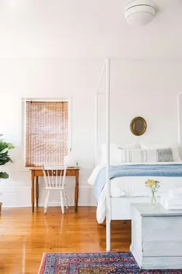 a white bedroom with a bed and a desk at Babcock-Hubbs House in Carrying Place