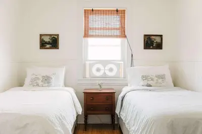 two twin beds in a room with a window at Babcock-Hubbs House in Carrying Place