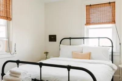a bedroom with a bed with white sheets and pillows at Babcock-Hubbs House in Carrying Place
