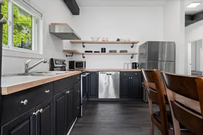 a kitchen with black cabinets and stainless steel appliances at Lake lodge 6 in Frankford