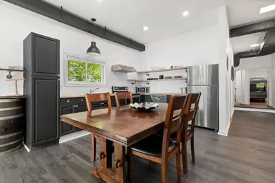 a kitchen with a wooden dining table and chairs at Lake lodge 6 in Frankford