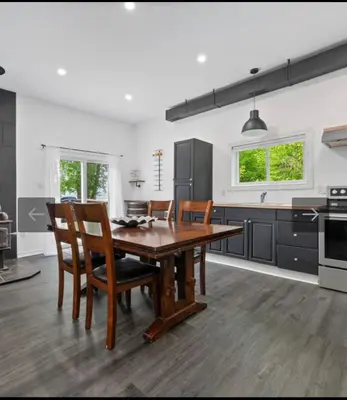 a kitchen with a wooden dining table and chairs at Lake lodge 6 in Frankford