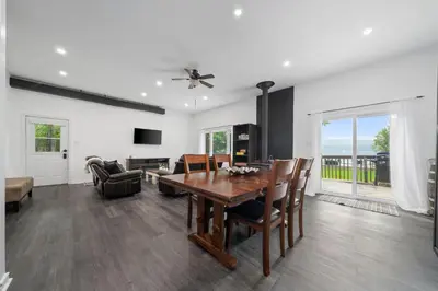 a dining room with a table and chairs and a couch at Lake lodge 6 in Frankford